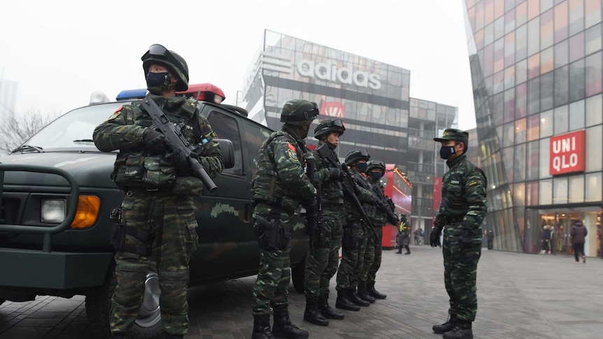 Armed police stand outside a popular shopping locale in Beijing.