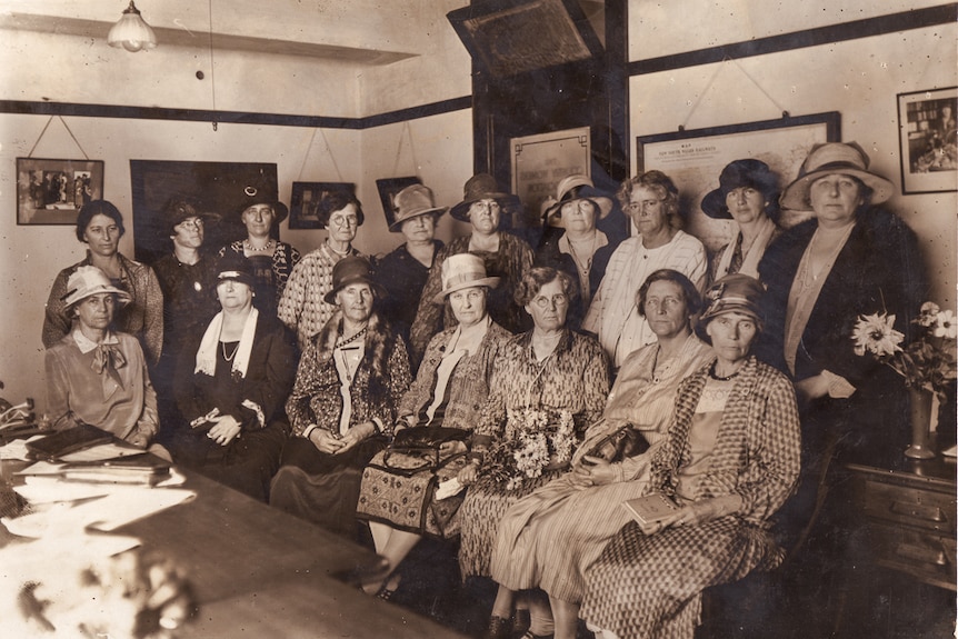 A group photo of women dressed in 1920s clothing.