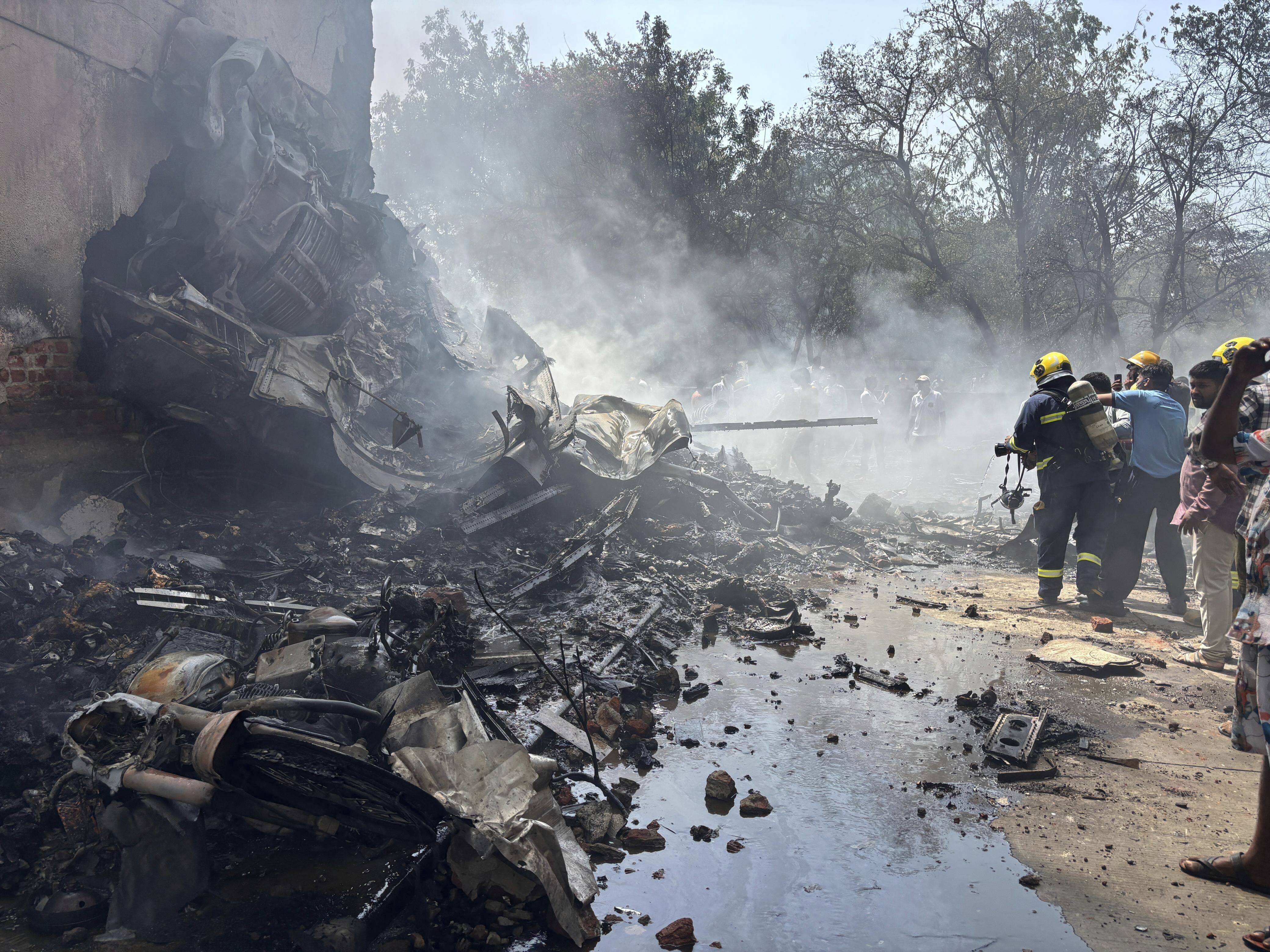 Firefighters work at the site of a crashed airplane 