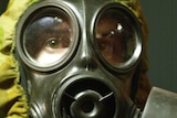 A studio shot of a soldier wearing a gas mask