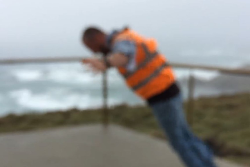 Tour guide takes on 140kph winds at Woolnorth wind farm in northwest Tassie