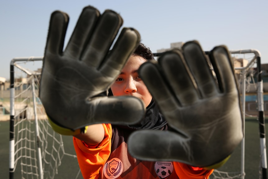 woman wearing goalkeeper gloves
