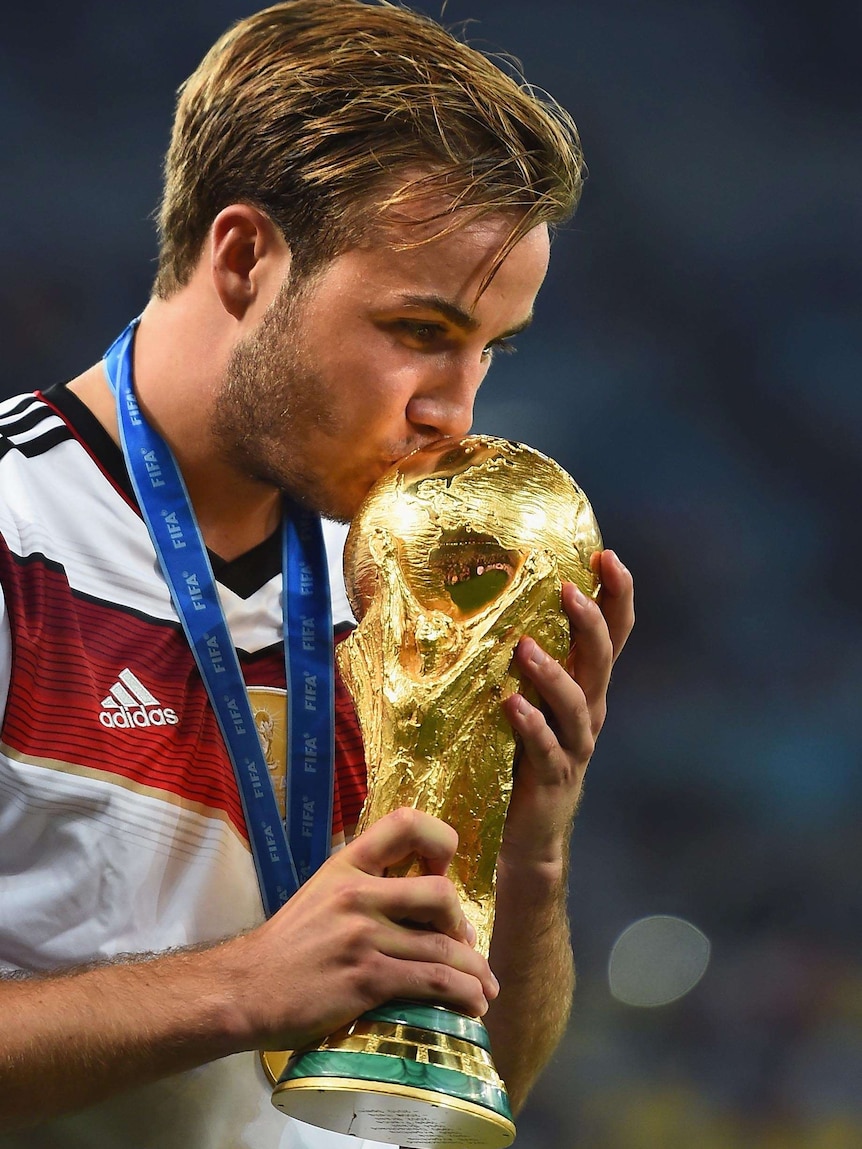 Mario Goetze kisses the World Cup trophy after Germany defeated Argentina in the World Cup final.