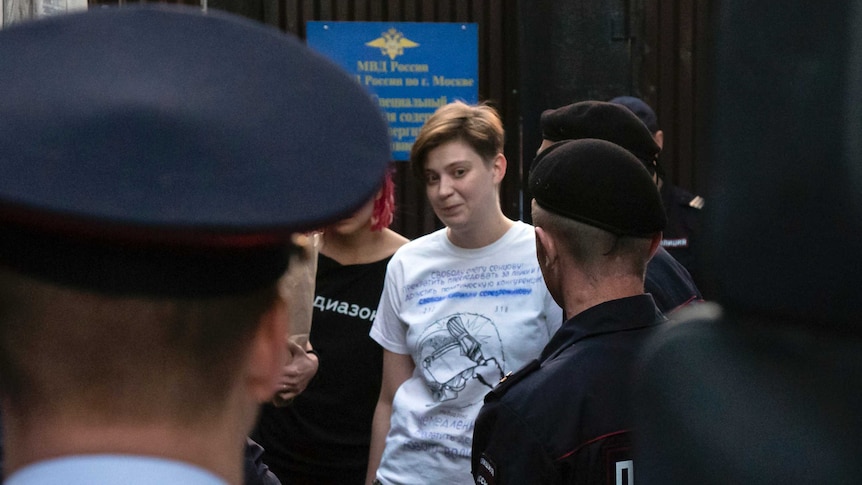 Olga Pakhtusova, a member of the feminist protest group Pussy Riot, is lead out of jail and into a police van