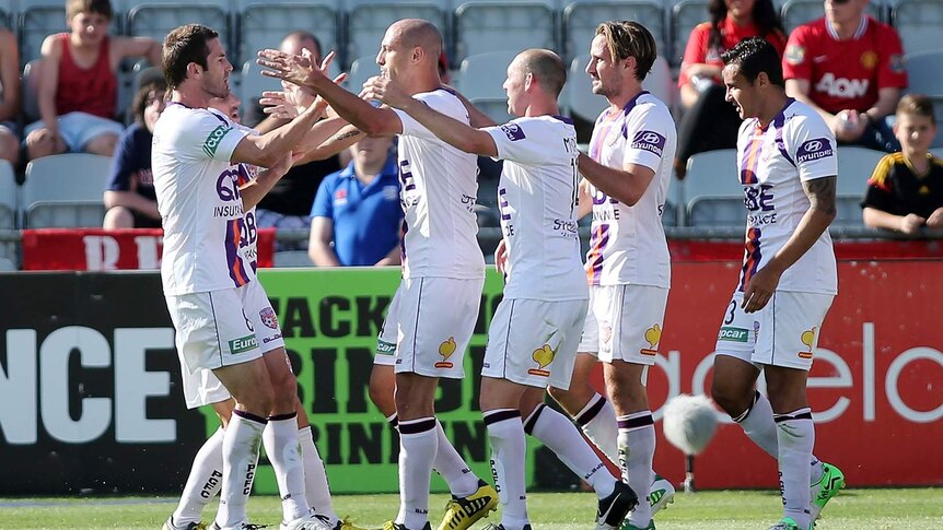 Perth Glory players congratulate goal-scorer Billy Mehmet in Perth's 1-1 draw with Adelaide United.