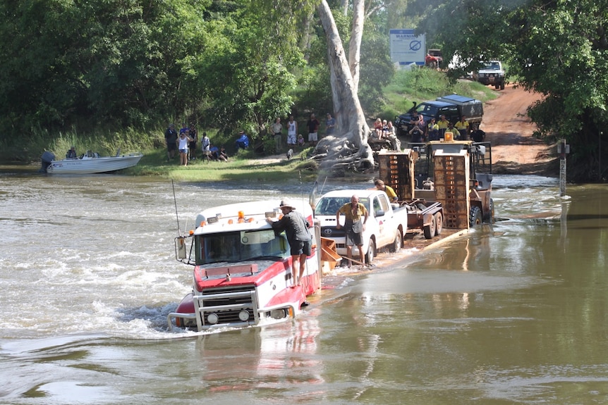 A truck is pushed out of the water at Cahills Crossing.