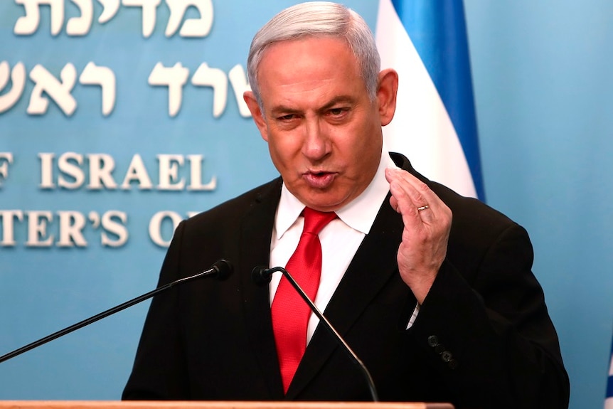 Prime Minister Benjamin Netanyahu gesturing while giving a speech.