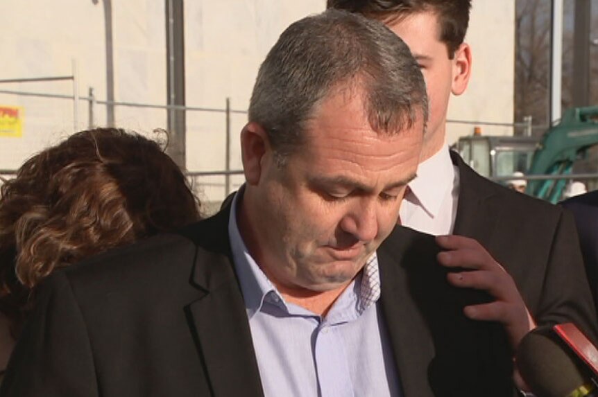 A man appears upset as he talks to the media outside the ACT Supreme Court.