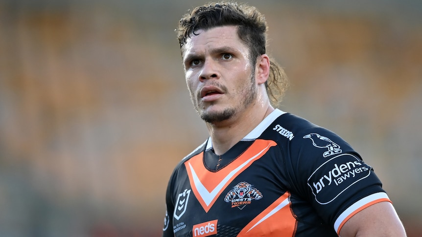 A Wewsts Tigers NRL player looks to his left during a match.