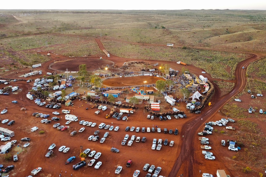 An aerial shot of the rodeo, with cars, campers and a ring.
