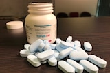 PrEP or Pre-Exposure Prophylaxis bottle and tablets on a table.