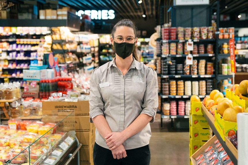 A woman wearing a mask in a supermarket.