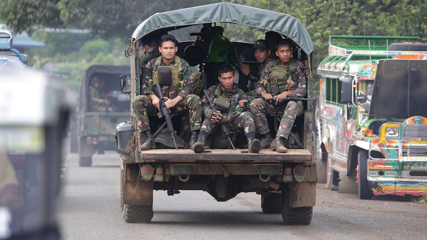 Soldiers ride a military vehicle on the outskirts of Marawi city, southern Philippines.