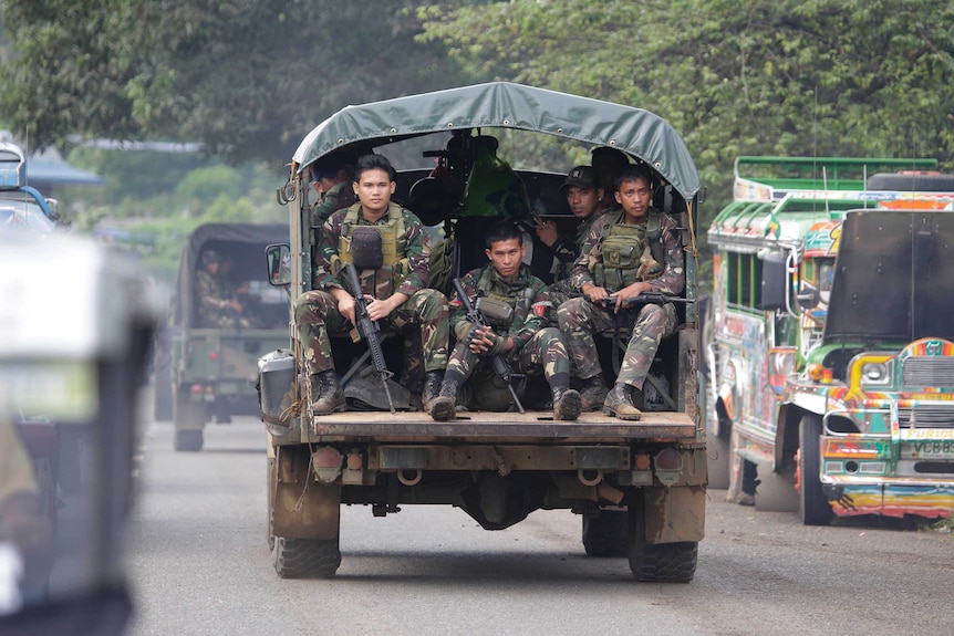 Soldiers ride a military vehicle on the outskirts of Marawi city, southern Philippines.