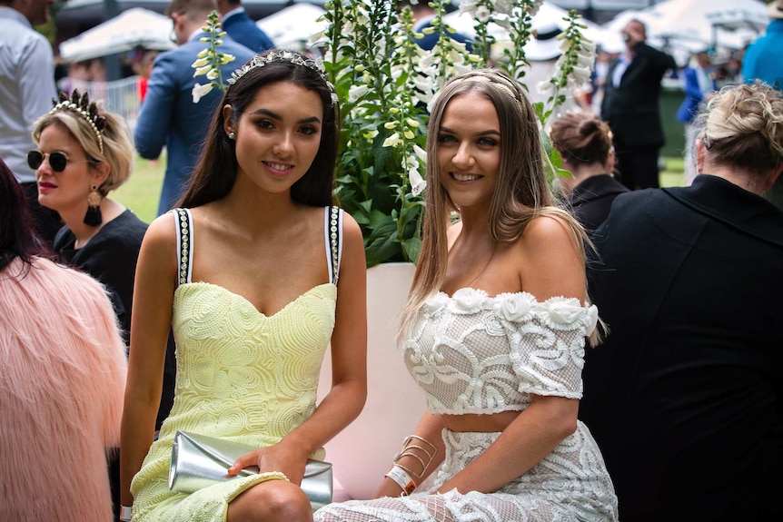 Two young women pose for a photo at the Melbourne Cup.