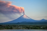 Pink-grey smoke billows from the top of the Klyuchevskaya Sopka volcano, near the village of Klyuchi in Russia.