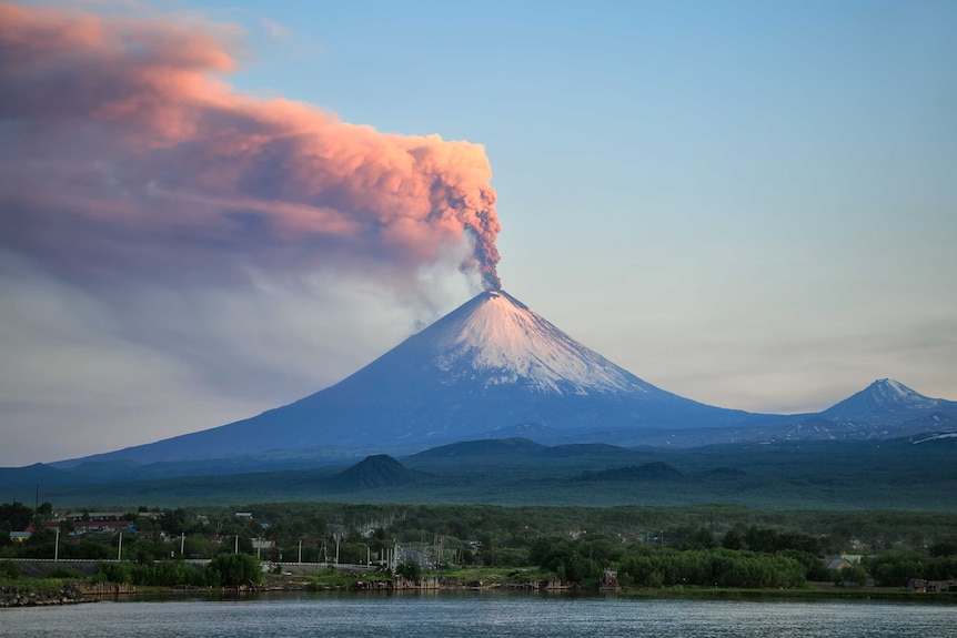 Pink-grey smoke billows from the top of the Klyuchevskaya Sopka volcano, near the village of Klyuchi in Russia.