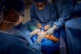 A patient is seen in theatre during a medical procedure.