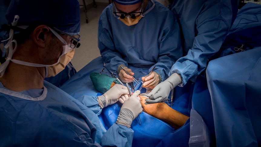 A patient is seen in theatre during a medical procedure.