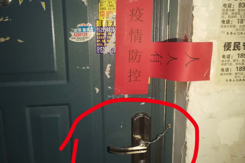 A green door was sealed with red papers in Xinjiang, China.