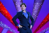 British comedian Michael McIntyre with hands on hips during a show.