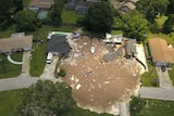 Debris is strewn about after a sinkhole damaged two homes in Land O' Lakes