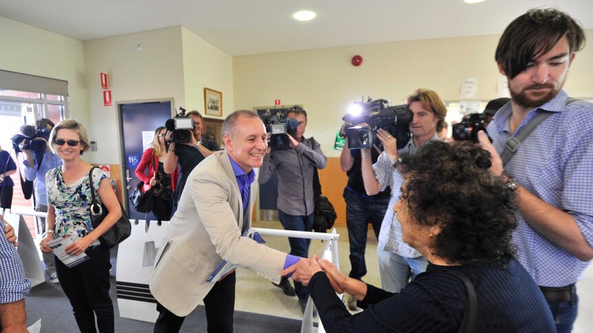 Jay Weatherall greets an elderly lady at a polling booth