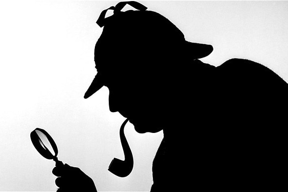 A silhouette of Sherlock Holmes with pipe and magnifying glass.