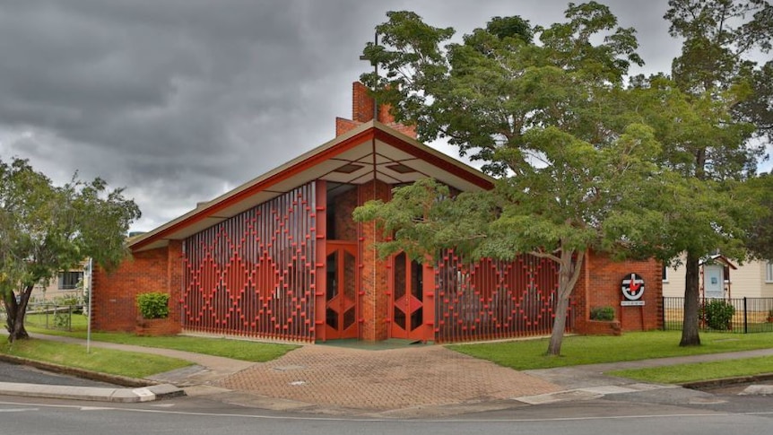 An usual-looking red brick church building.