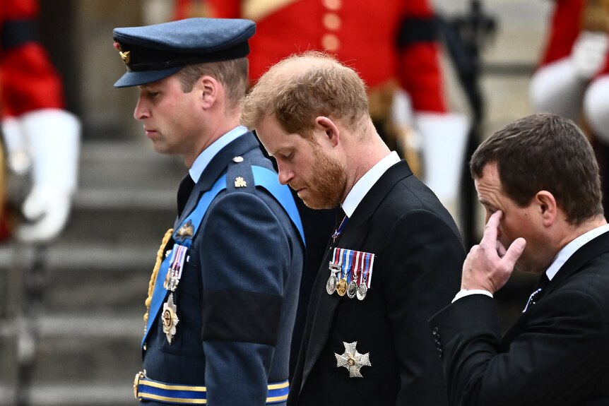 Britain's Prince William and Britain's Prince Harry appear emotional before the Queen's funeral. 