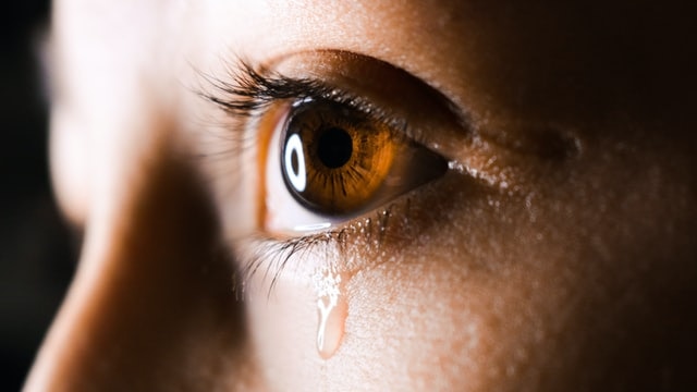 A woman with a tear running down her face for story on why we cry and how it helps