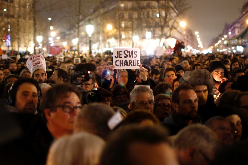 A man holds a placard reading 'I am Charlie' at a vigil at Place de la Republique in Paris.