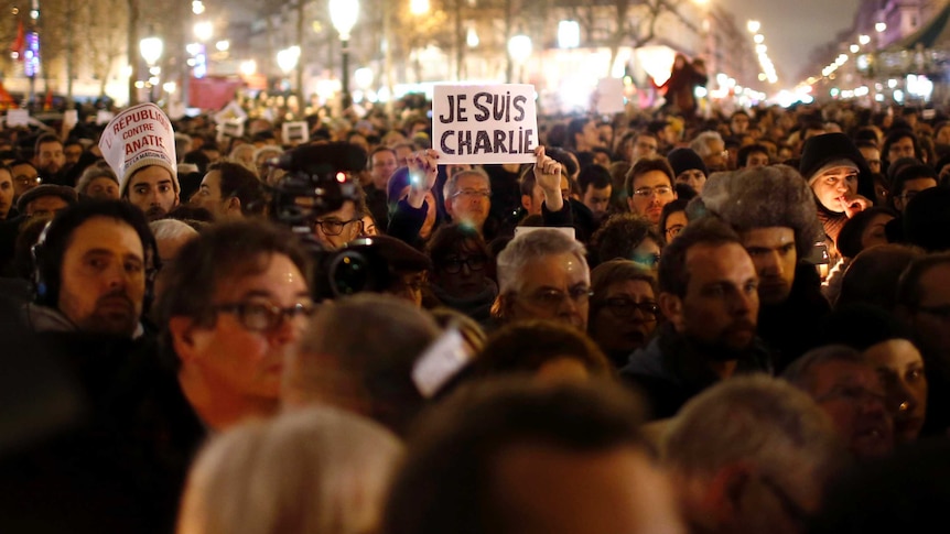 A man holds a placard reading 'I am Charlie' at a vigil at Place de la Republique in Paris.