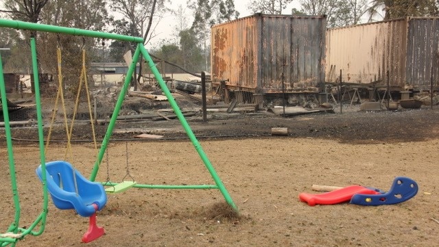 Playground with burnt out land in the background