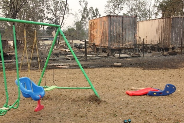Playground with burnt out land in the background