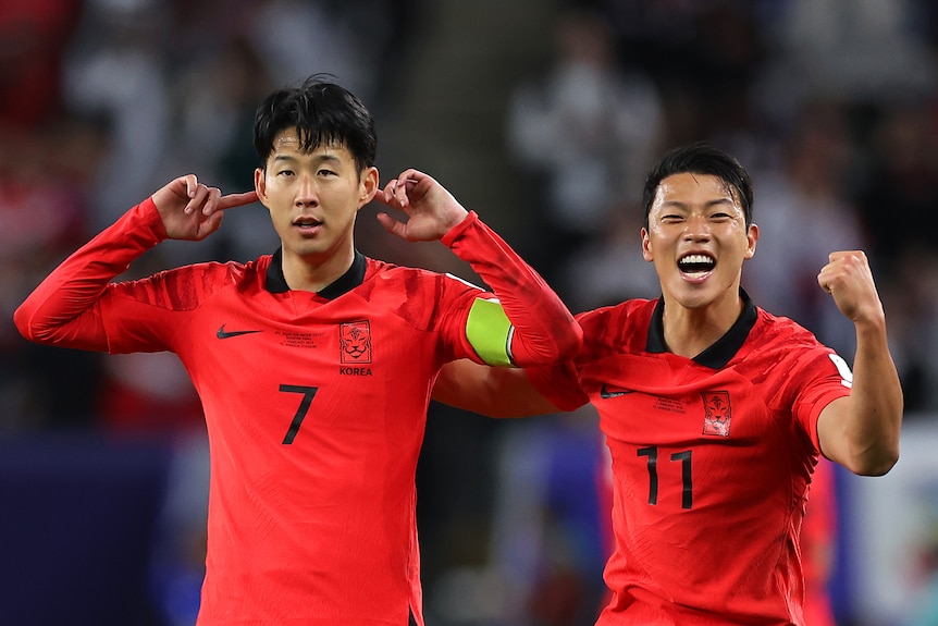 Two South Korean players celebrate a goal during the Asian Cup quarterfinal against the Socceroos.