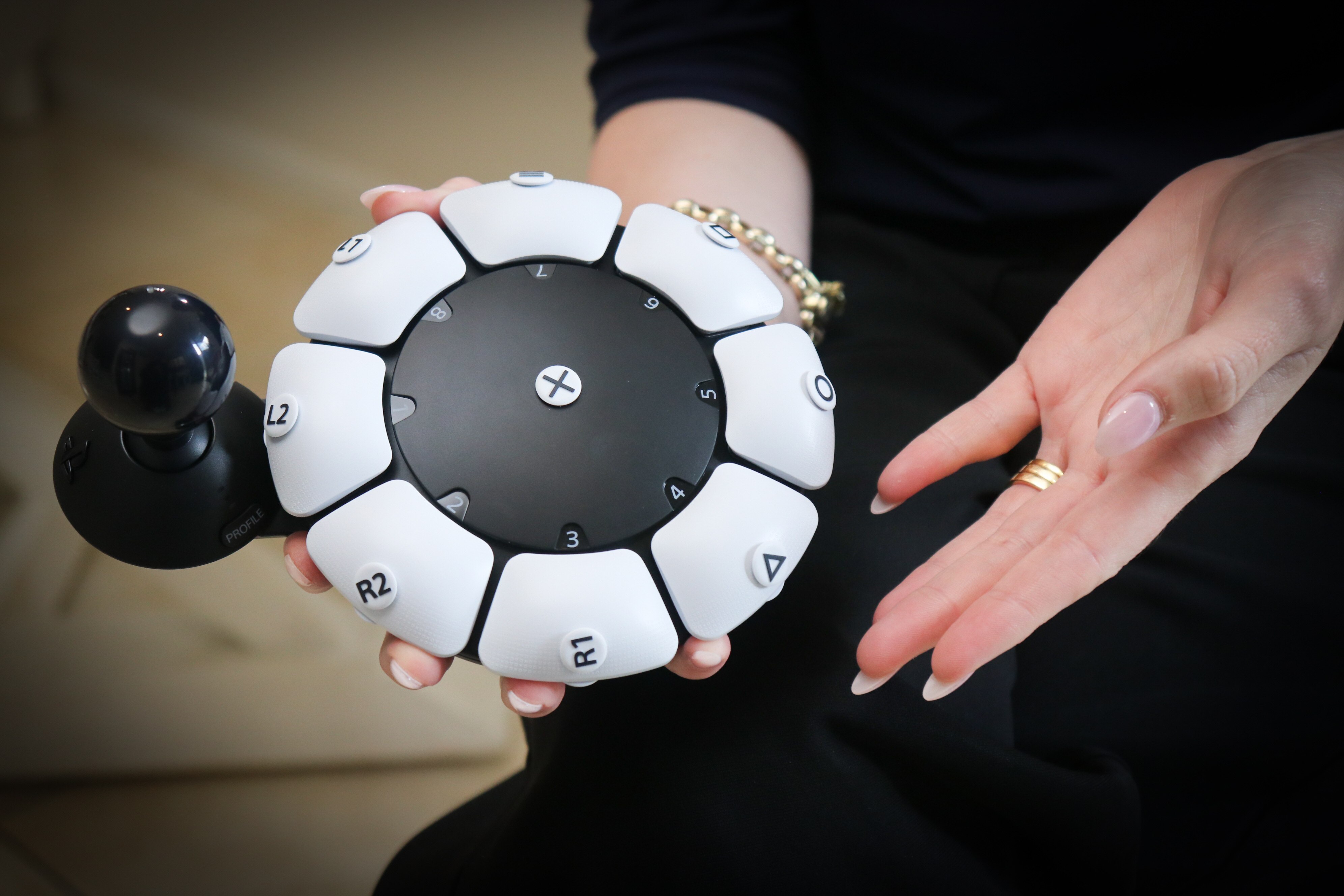 A close-up of a round technological device with buttons and a joystick