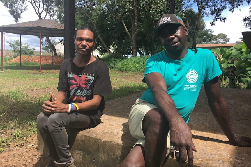 Daryl Daniels and Nicholas Miller sitting in a park.