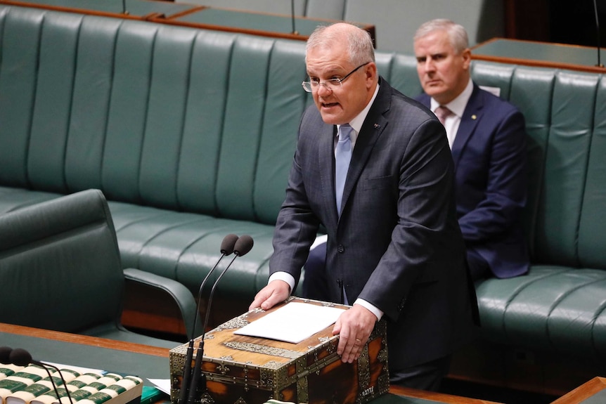 Scott Morrison speaks at the despatch box while Michael McCormack watches on.