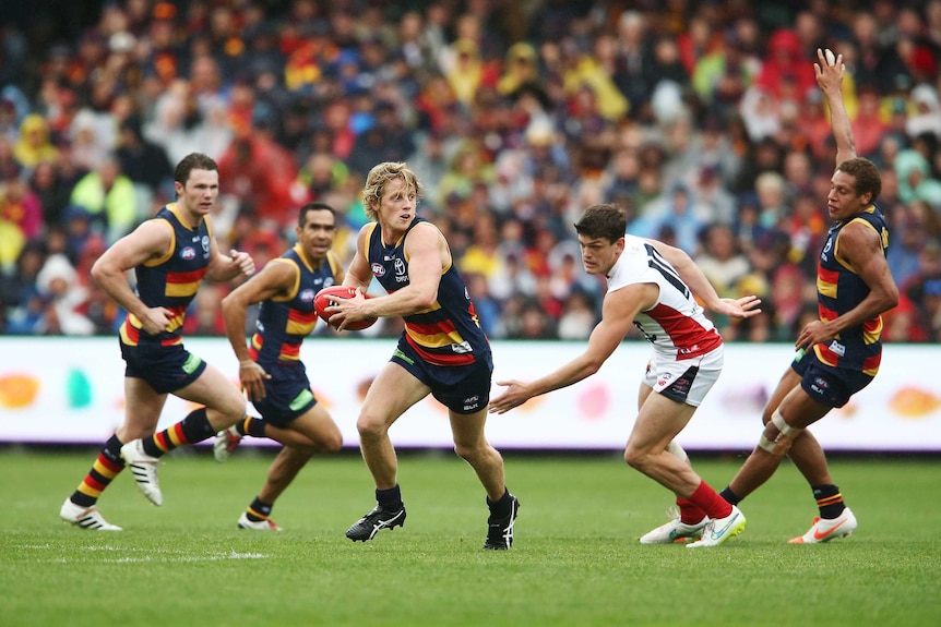 Rory Sloane emerges with the ball for Adelaide