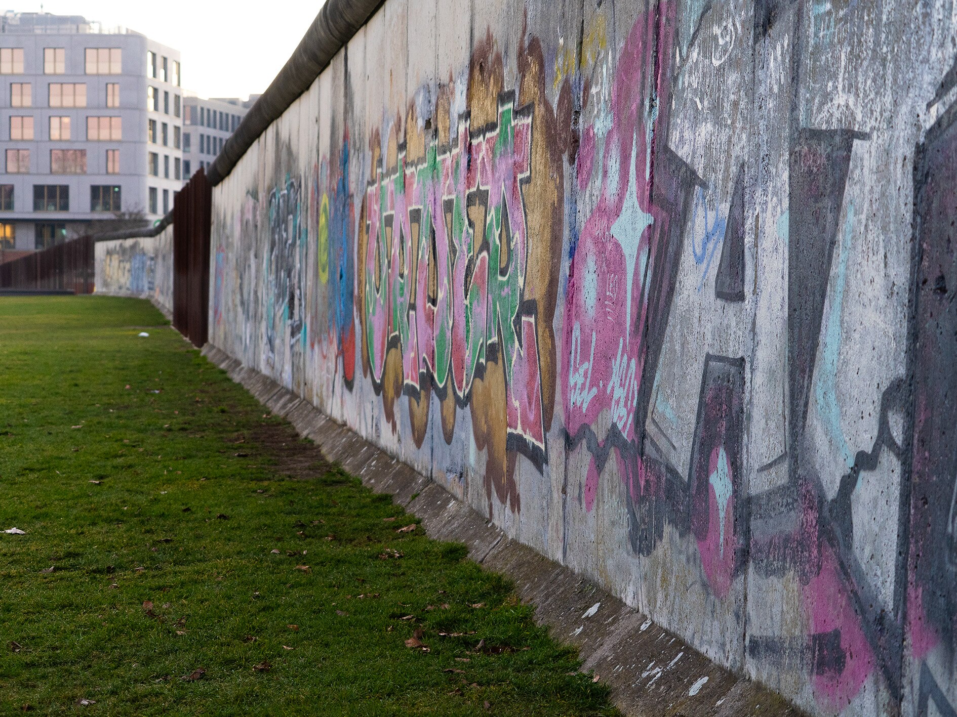 A concrete wall covered in grafitti.
