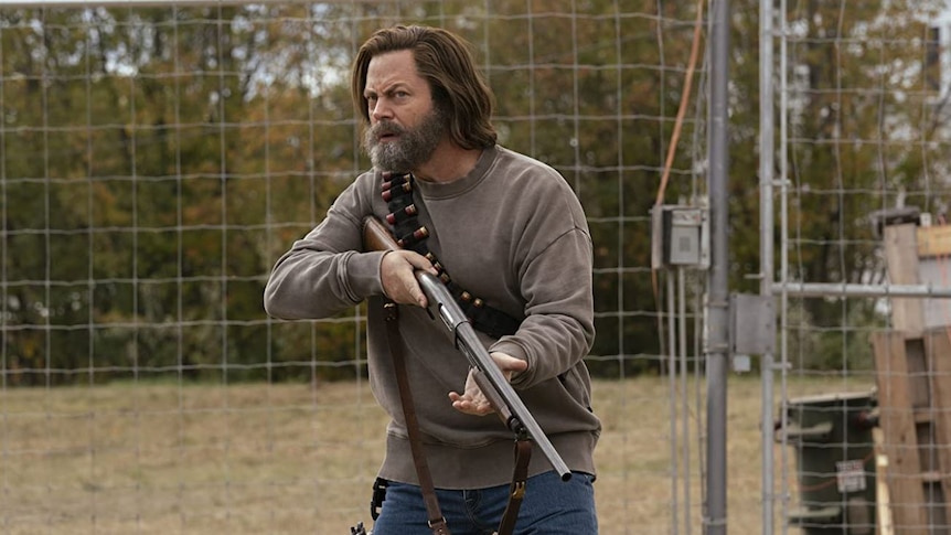 Nick Offerman as Bill holding a gun in a still image from HBO's The Last of Us
