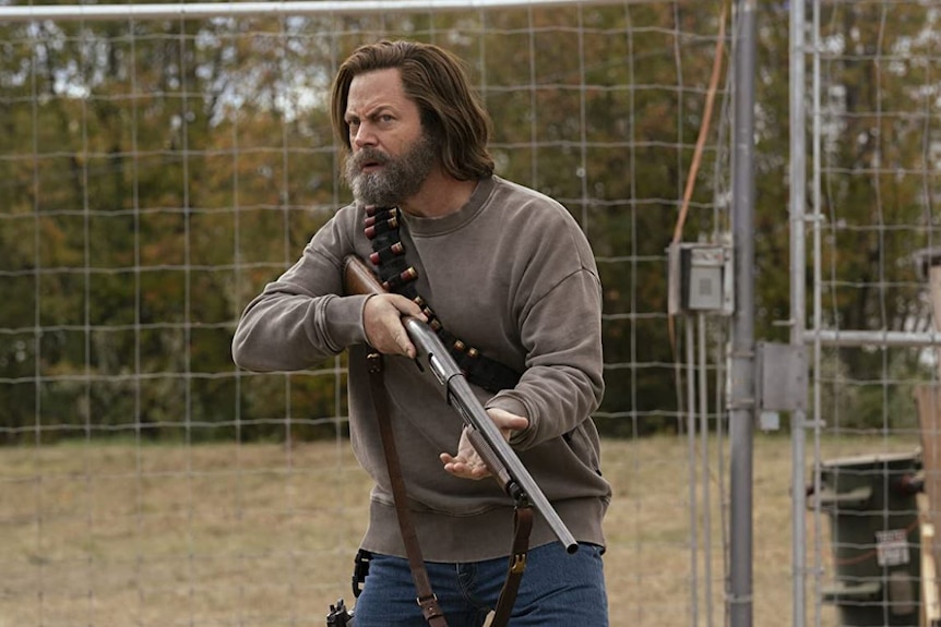 Nick Offerman as Bill holding a gun in a still image from HBO's The Last of Us