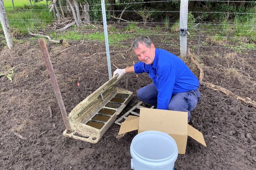 David Brill places Hoggone tray into a bait box.