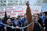 Demonstrators shout slogans against the government's austerity measures during a protest outside the Greek Parliament in Athens.