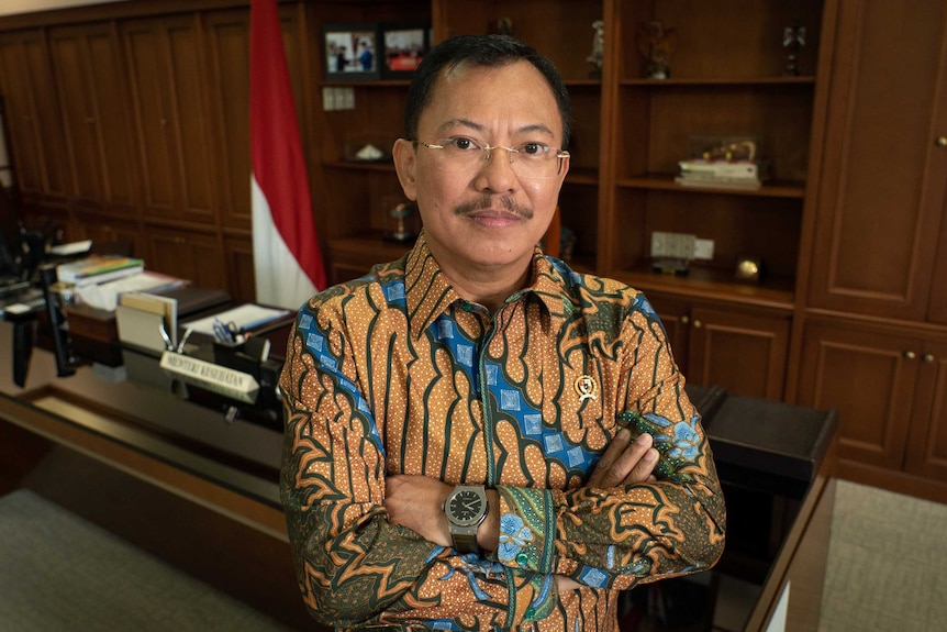 Health Minister Terawan Agus Putranto standing cross armed in his office