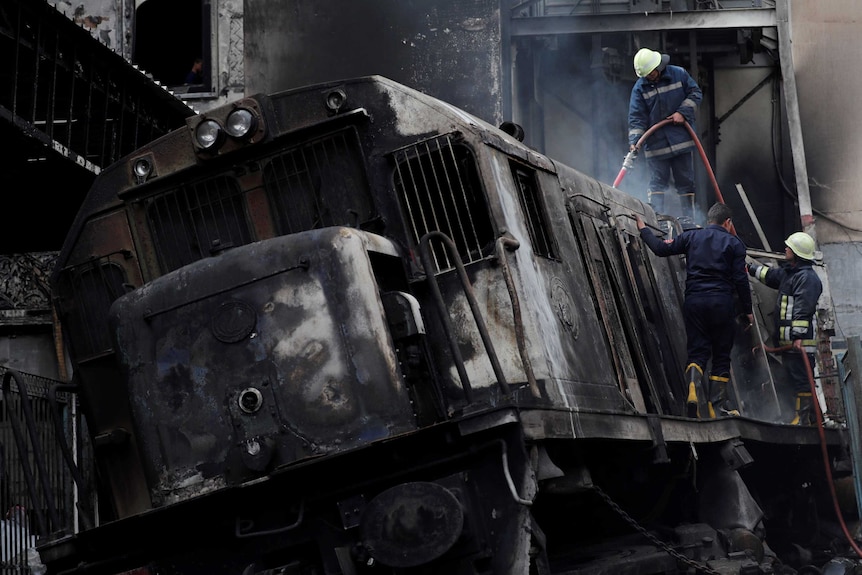 Rescue workers put out a fire at the main train station in Cairo, Egypt, February 27, 2019.