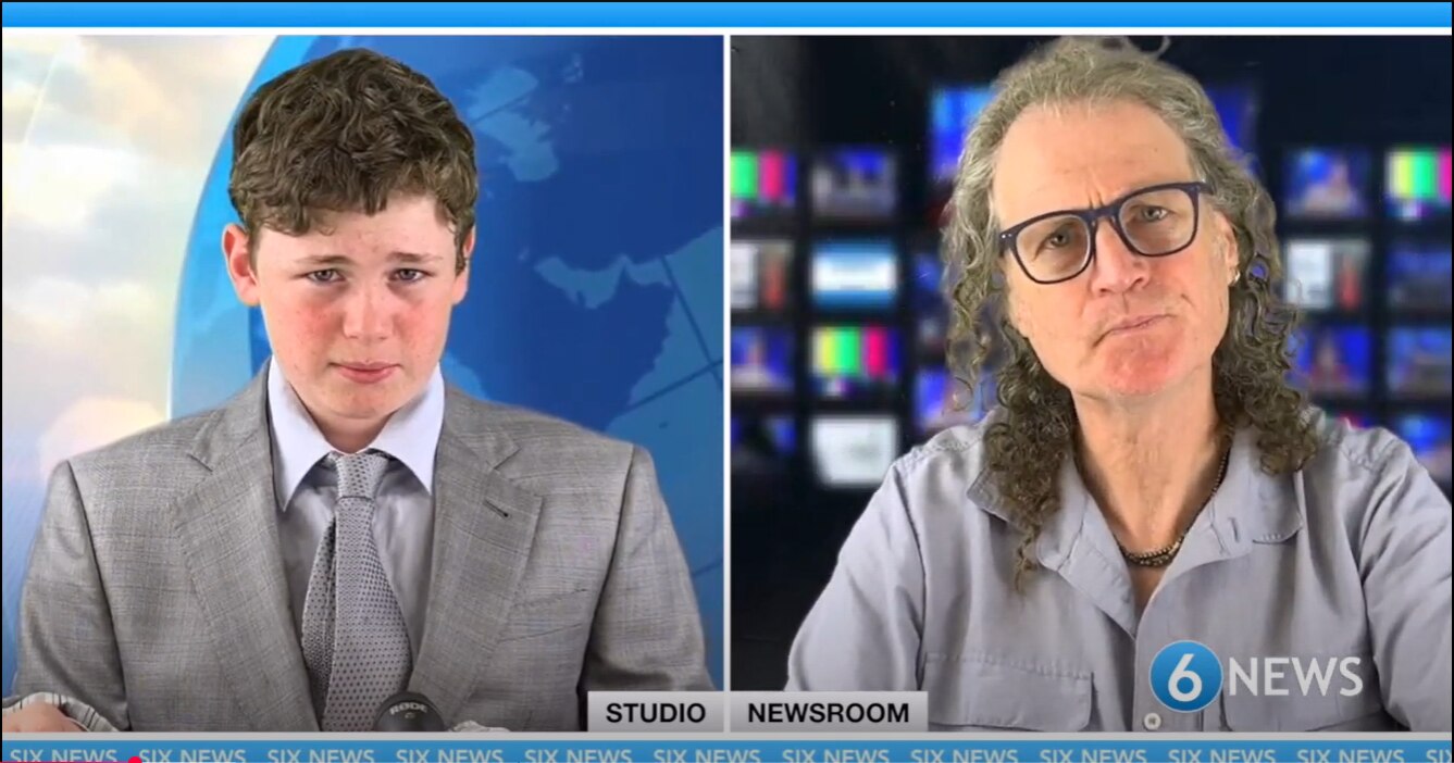 Head shots of a young leo in grey suit and father with long hair and open shirt appearing side by side in studio