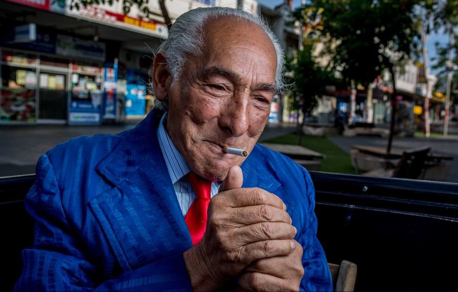 Footscray resident John Halilovich lights a cigarette.