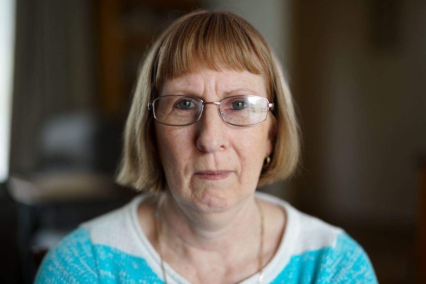 Meredith Dallow looks to the camera. She wears glasses, her hair is cut in a bob and she wears a blue and white top.